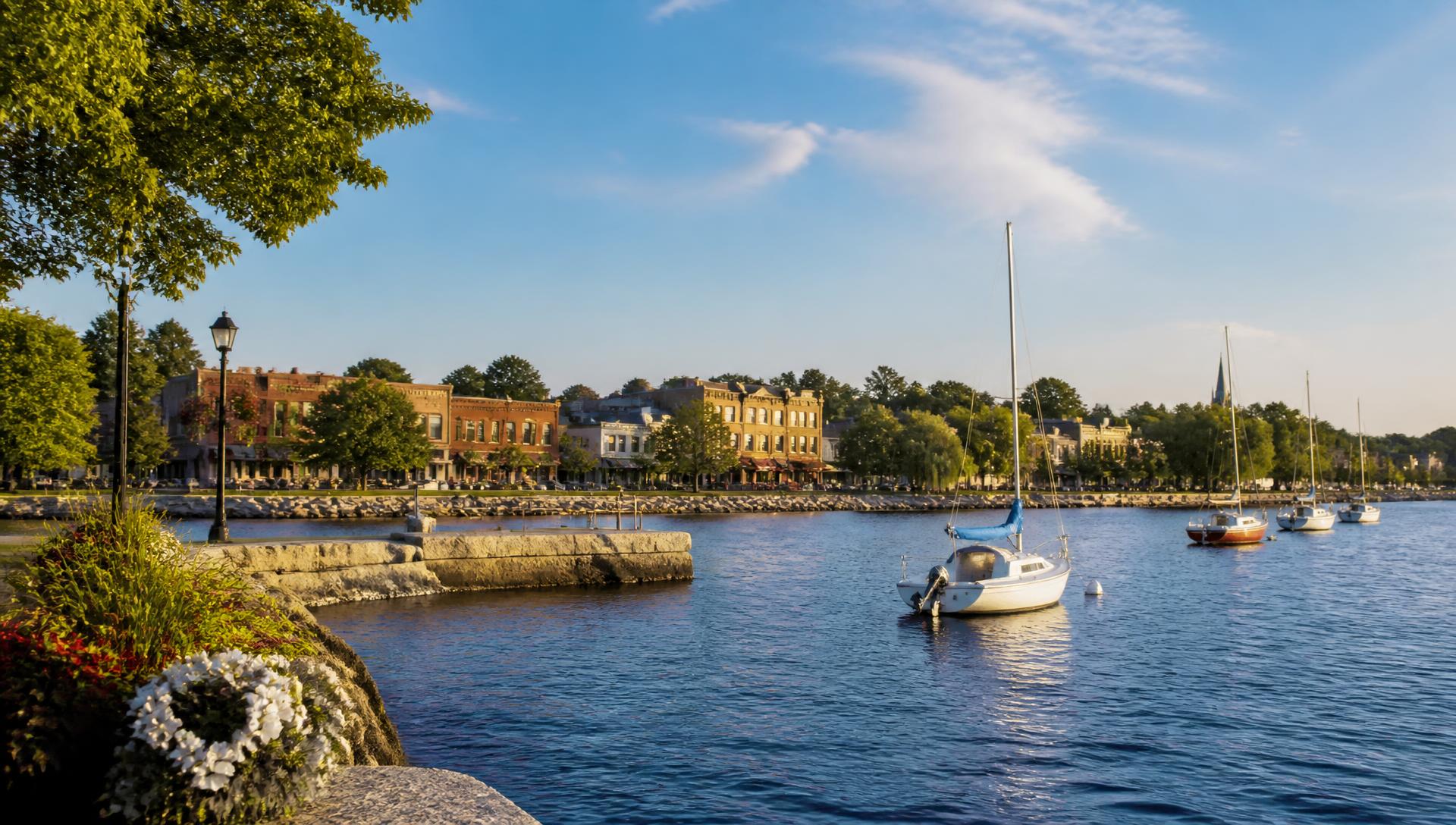 Oakville harbour at golden hour with sailboats and the historic downtown waterfront